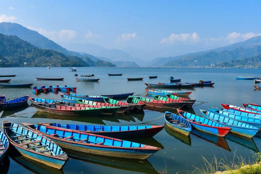 Boats floating on Phewa Lake in Pokhara with Annapurna mountains in the background