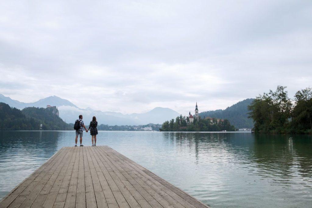 Couple holding hands while walking along Lakeside Pokhara beside Phewa Lake in Nepal.