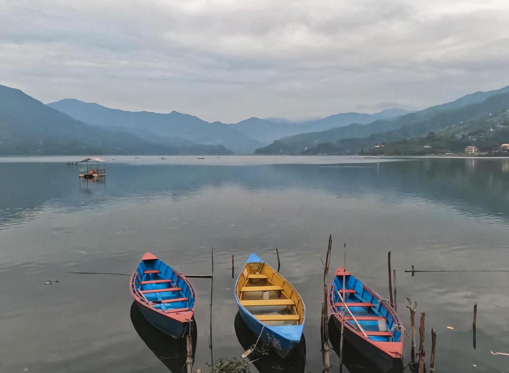 Boats floating on Phewa Lake at Lakeside Pokhara with calm water scenery
