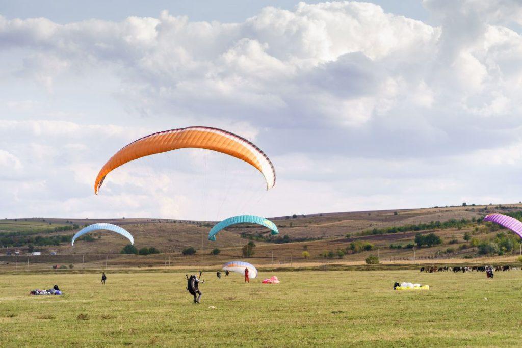 Paragliding participants gathered on the ground at Sarangkot, Pokhara, before takeoff.