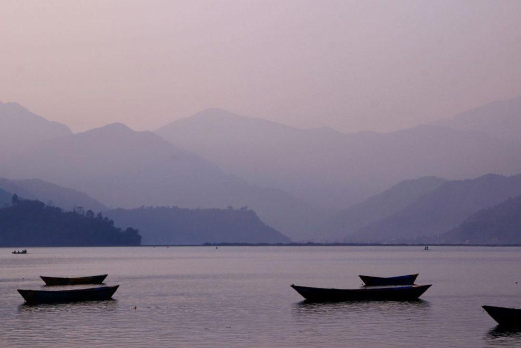 Boats on Phewa Lake in Pokhara at sunset