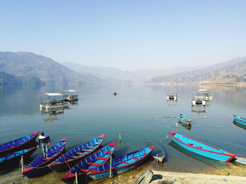 Wooden boats floating on Phewa Lake in Pokhara